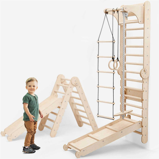 Indoor climbing wall set with wooden ladder, gym rings, rope ladder, slide, and toddler playing