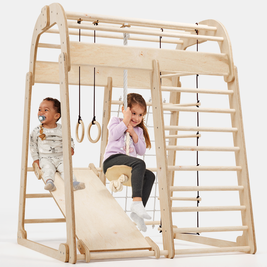 6in1 indoor wooden playset with climbing net, slide, gym rings, hanging ladder, and disc swing with children playing