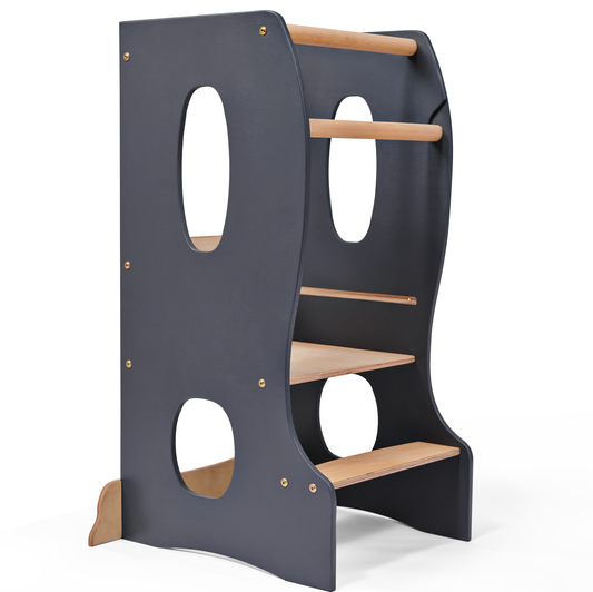 Gray wooden Montessori Lernturm learning tower with adjustable platform and safety rails for children.