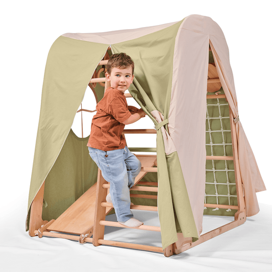 Child playing inside indoor wooden playground covered with beige and green Spielzelt-Abdeckung tent canopy